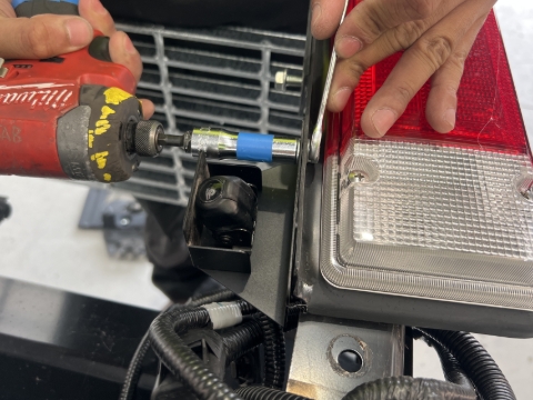 <p>Remove the reverse camera from the LHS taillight using a 10mm spanner and 10mm socket.</p>