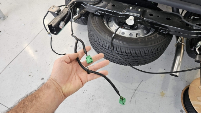 <p>Locate License Plate light loom at passenger side of rear chassis</p>