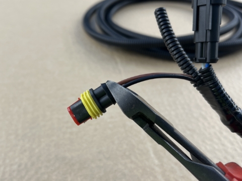<p>Cut each wire (brown/black) as close to the connector as possible.</p>