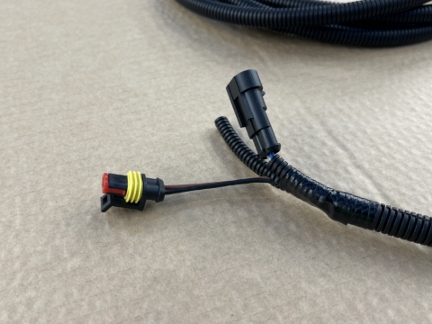 <p>Peel back the corrugated sleeving from the longer connector branch (brown/black wires).</p>