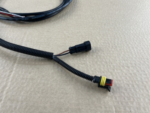 <p>Remove the corrugated split sleeve from the shorter connector branch (brown/black wires).</p>