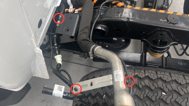 <p>Cut the cable ties holding the rear axle breather and fuel tank vent hose to the fuel neck and chassis.</p>