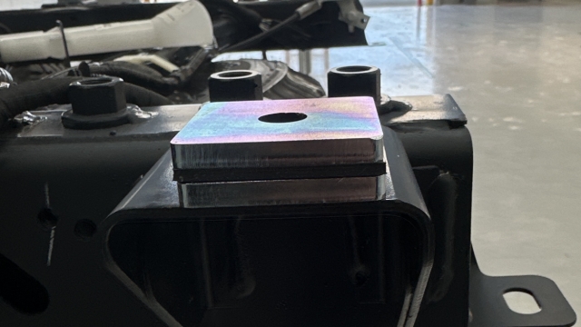 <p>Install the packer stacks over each mounting point on the vehicle chassis ensuring the washer is sitting straight with the chassis mount.</p>