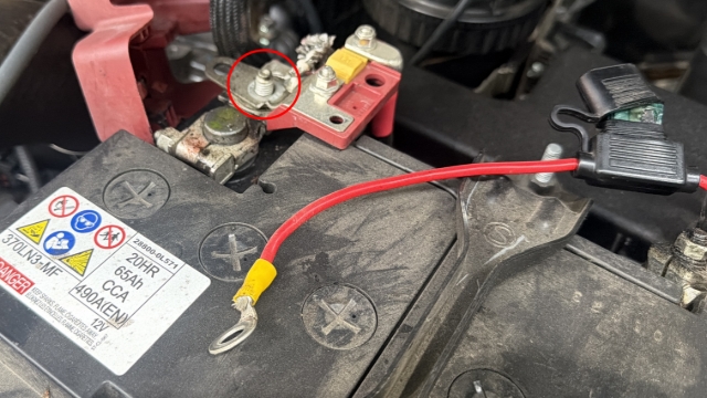 <p>Disconnect the charger from the positive terminal using a 12mm spanner.</p>
