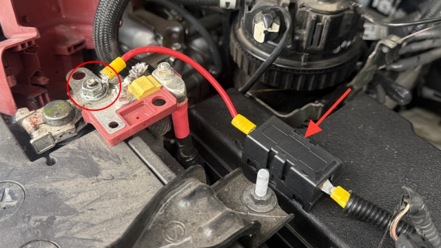 <p>Cover the fuse, then reconnect the charger to the positive terminal of the battery using a 12mm spanner.</p>