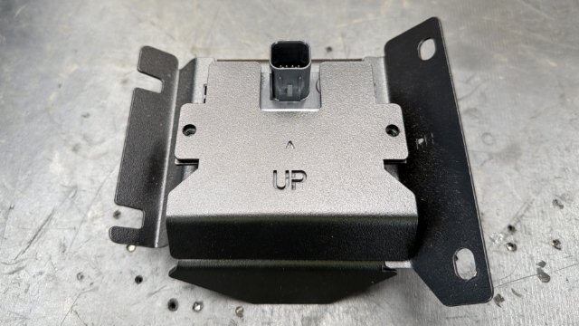 <p>Place the backing plate over the sensor.</p>