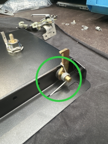 <p>slide the spring on to the end of the shaft and hook around the shaft.<br></p>