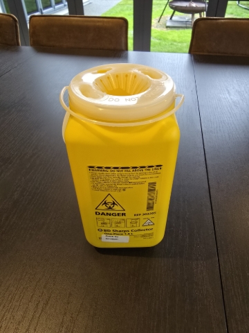 <p>Discard of the old needles into the yellow Sharps bin</p>