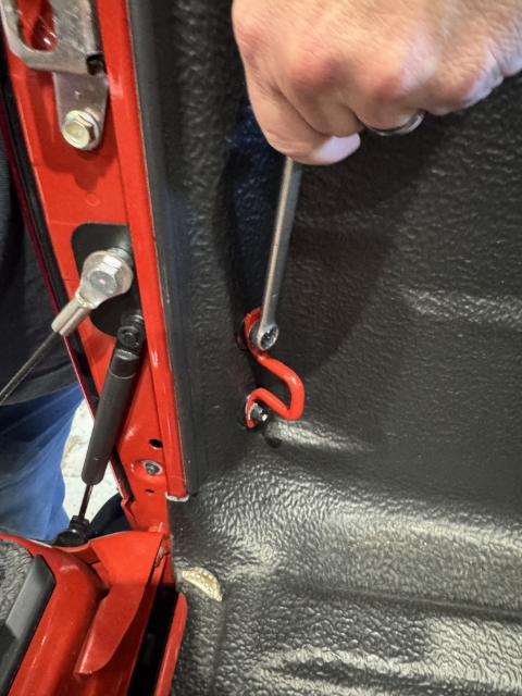 <p>Remove the Two bolts retaining the tie down bracket and tub liner at the rear.</p><p>Keep the bolts and the tie down bracket for later.</p>