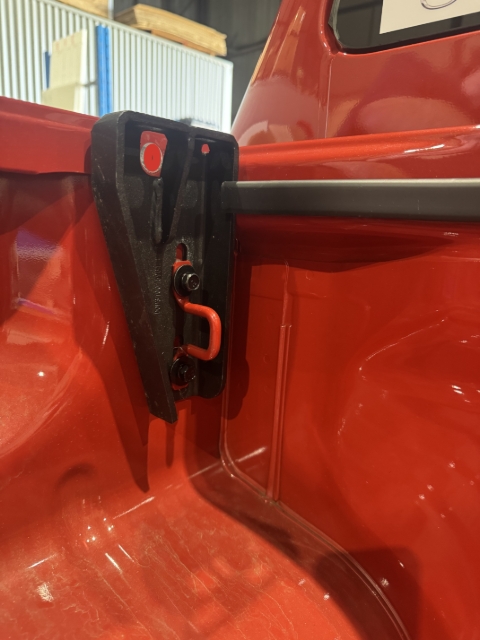 <p>Fit the Front brackets in place as shown using the M8x25mm bolts with captive spring and flat washers - Refit the tie down loop back in place too.</p><p>Leave the bolts finger tight to allow for adjustment when fitting the tub rack.</p>