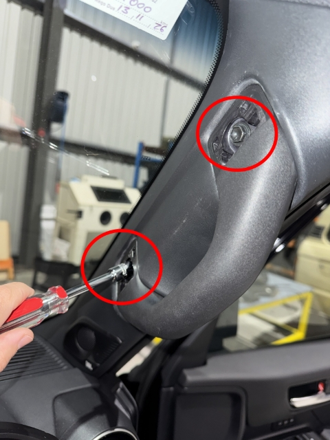 <p>Use the 10mm Socket and Driver to remove the two bolts securing the grab handle.</p>