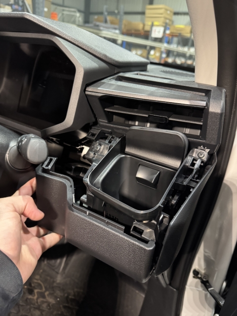 <p>Unclip the panel under the cup holder, that we will be replacing.</p>