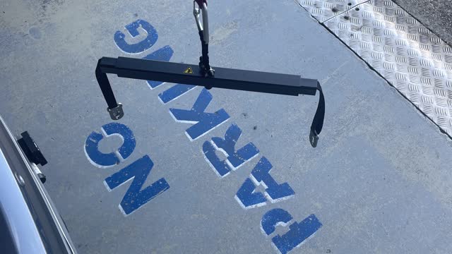 <p>Attach spreader bar mounting tabs to mounting point on wheelchair/scooter</p>