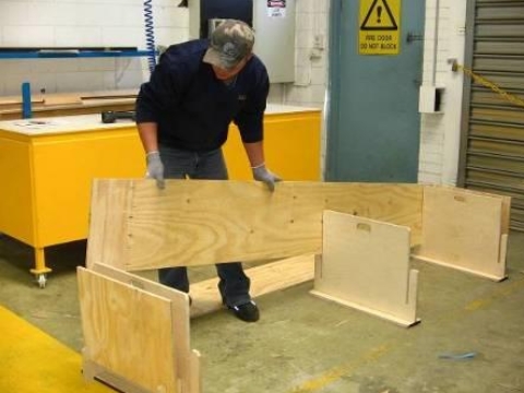 <p>Place plywood board into the holding frames. This will align plywood sides into position to create coffin box.</p>