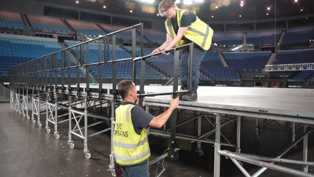<h1>Roles (Two Person Job)</h1><p></p><p>Removing handrails is a <strong>two person job</strong>.</p><p></p><ul><li><p>One on Floor</p></li><li><p>One on Stage</p></li></ul><p>The floor person unpins, lowers and places the handrail back in the stillage.</p><p></p><p>The stage person holds the handrail as it is unpinned and passes it to the person on the ground.</p><p></p><p><strong>Important: NEVER remove the handrail by yourself.</strong></p>