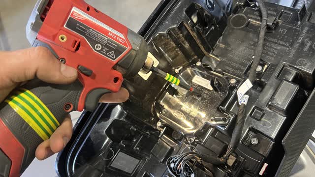<p>Use a Phillips head screwdriver to remove the radar bracket from the tail light assembly</p>