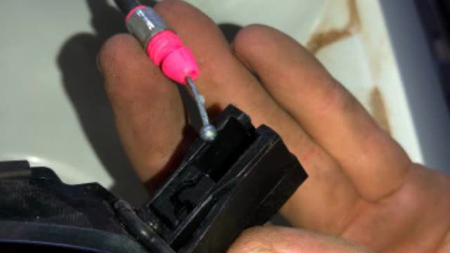 <p>Detach cable from black bracket</p>