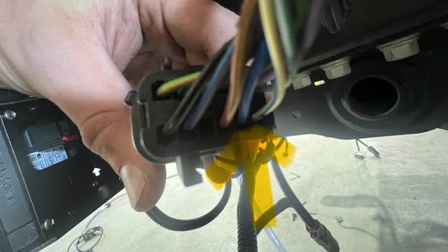 <p>On the vehicle side of the plug, identify the wire shown. It is on the bottom row (note the orientation of the plug), and the 2nd wire from the right.
Colour = Blue with a pink/Brown stripe</p>