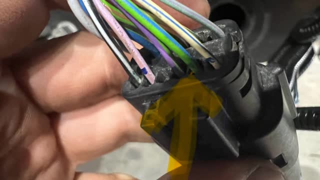 <p>On the vehicle side of the plug, identify this wire. It is on the bottom row (note the orientation of plug). It is the 2nd wire from the right. Colour = Green with a blue stripe.</p>