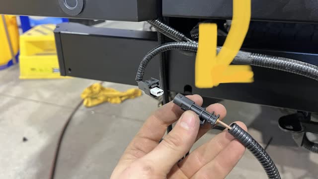 <p>On passenger side. Plugs into revering sensor harness</p>