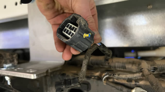 <p>On the vehicle, passenger side, Identify this plug. It originally went to the 12v outlet in the Tub</p>