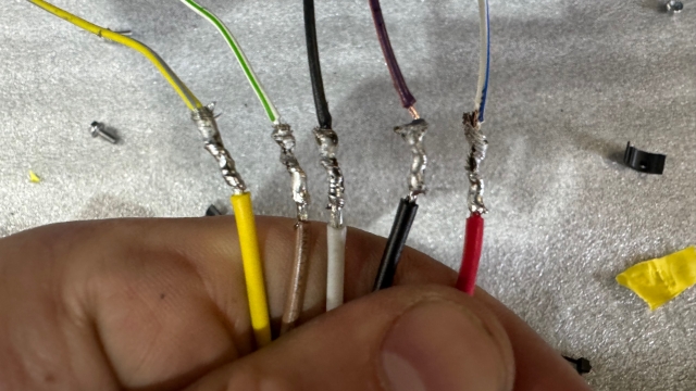 <p>Passenger side</p>
<p>Bottom wires (LED), top wires is vehicle harness.</p>
<ul>
<li>Yellow (indicator) to yellow with light purple stripe</li>
<li>Brown (park) to white with green stripe</li>
<li>White (earth) to black</li>
<li>Black (reverse) to purple with red stripe</li>
<li>Red (stop) to white with blue stripe</li>
</ul>