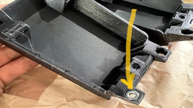 <p>Insert nuts into the 3D printed brackets</p>