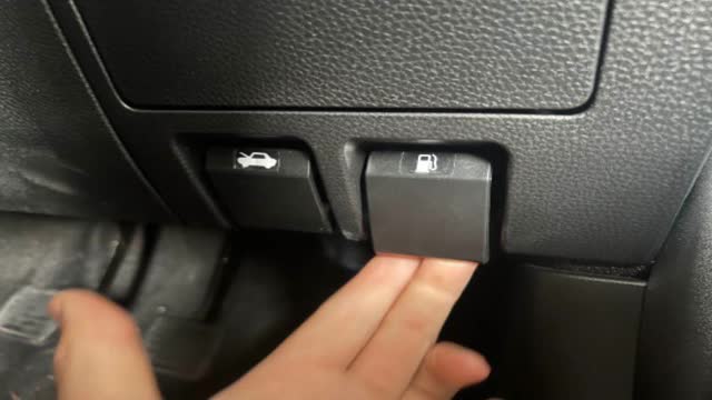 <p>Release the Fuel door, located under the steering wheel</p>