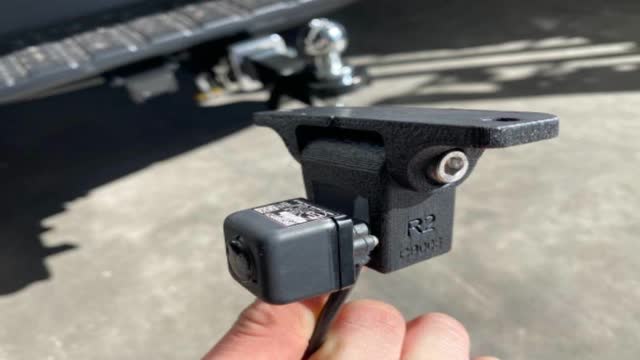<p>The sticker is on the TOP of the camera. Fit it to the bracket this way up.</p>
