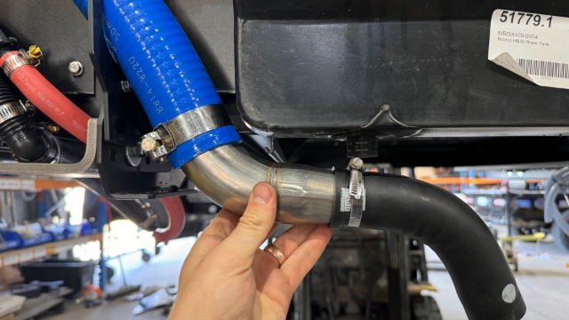<p>Fit the rubber elbow to the Trays fuel hoses.</p>
<p><em>It is possible to leave that rubber elbow attached to the vehicle, however this is easier.</em></p>