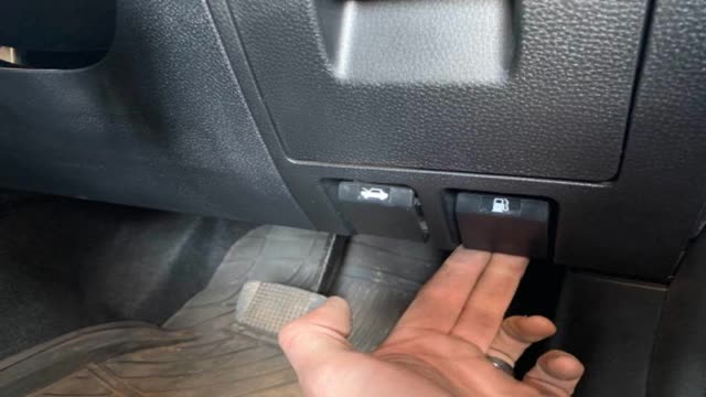 <p>Open the fuel door, located under steering wheel</p>