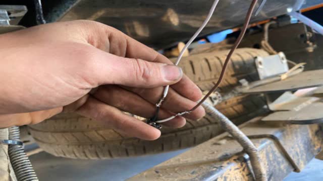 <p>Wire it to supplied licence plate harness</p>
<p>Brown = White (vehicle side)
White = Black (vehicle side)</p>