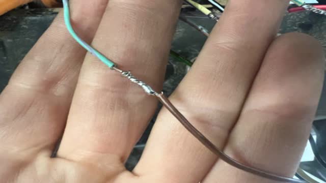 <p>Thin brown (it will be twisted up with the thin black wires) to light green with a purple stripe</p>