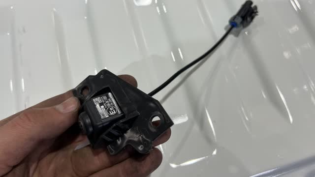 <p>Unplug the camera from its harness</p>