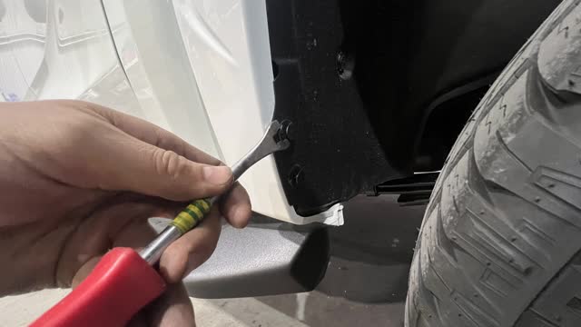 <p>Using a pry tool, remove the clips holding the plastic inner guard. Both sides of vehicle</p>