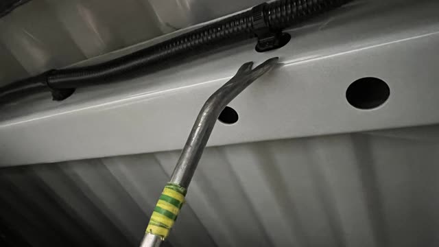 <p>Using a pry tool, remove the remaining wiring from the bottom side of the Tub</p>