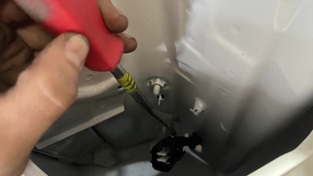 <p>Using a pry tool, break the clips holding the wiring to the inside of the tail light housing</p>
