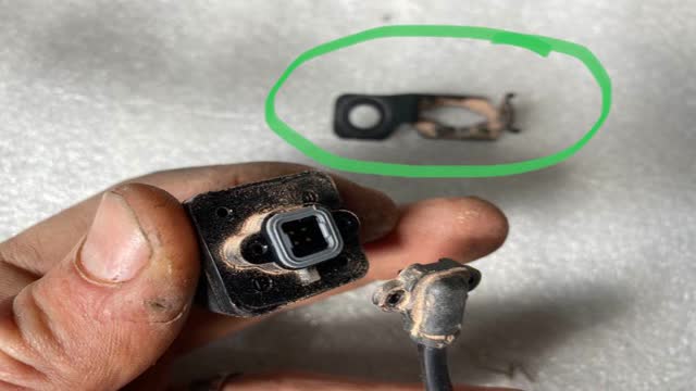 <p>Remove the steel mounting bracket, (highlighted green). Discard it, it is not required.</p>