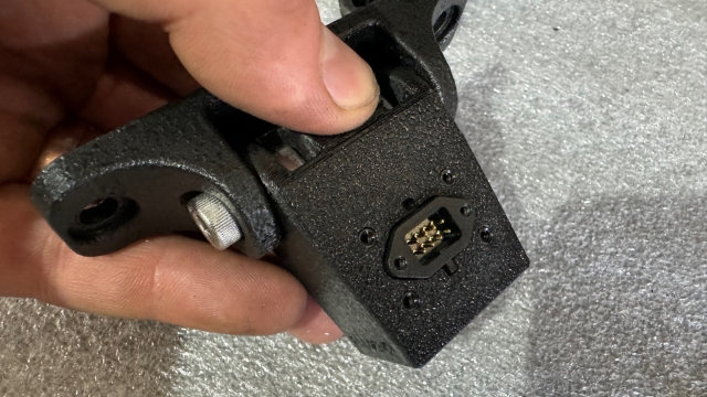 <p>Insert the camera into the camera bracket then refit the plug to the back of the camera</p>