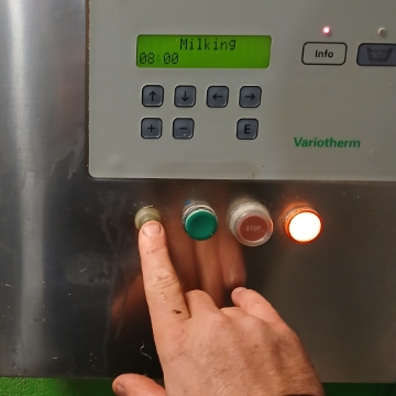<p>Hold <strong>black button </strong>in for 10 seconds </p><p>Air compresser in centre of dairy will start purging milk </p>
