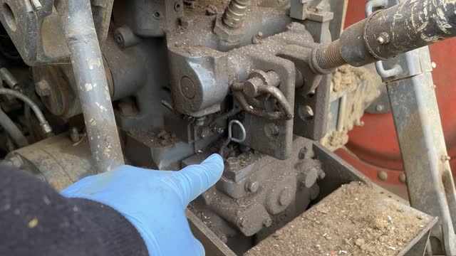 <p>Pull Hydraulic Oil dip stick out.
This is located at the back of the tactor, above the draw bar, to the left of the tip link attachment.</p>
