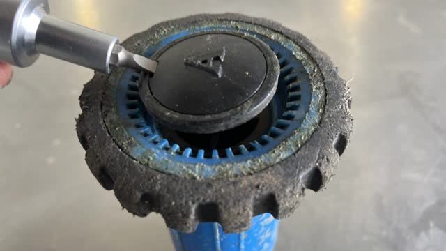 <p>Using a screwdriver, remove hose nozzle cap.</p>