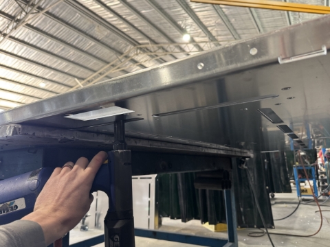 <p>Get a couple rivets in from the underside. </p><p><br></p><p><strong>Pro Tip: </strong></p><p>Do enough so that it can be flipped over. The rest will be done from the top side. </p>