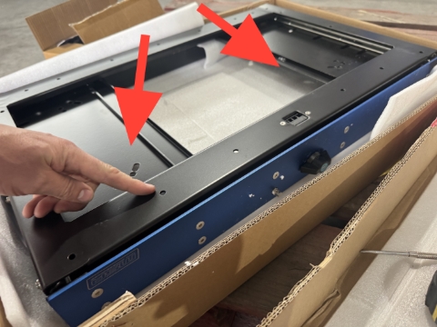 <p>Open the package, and flip it over. </p><p><br></p><p>Drill out these 2 x holes to 9mm, located at front of slide. </p>