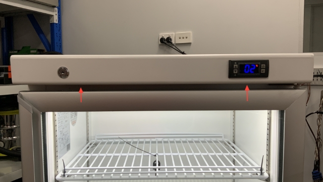 <ol><li><p>Using a Phillips head screwdriver, unscrew the two screws holding the front panel to the cabinet.</p></li></ol><blockquote><p>The screws are located under the panel. To access the screws the door needs to be open.</p></blockquote><p></p>