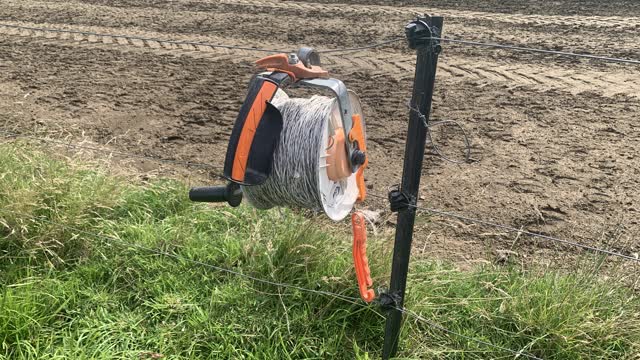 <p>Once you know where the fence is to be put up drop the reel at one end of the fence.
Hang it on the fence so you can see it.</p>