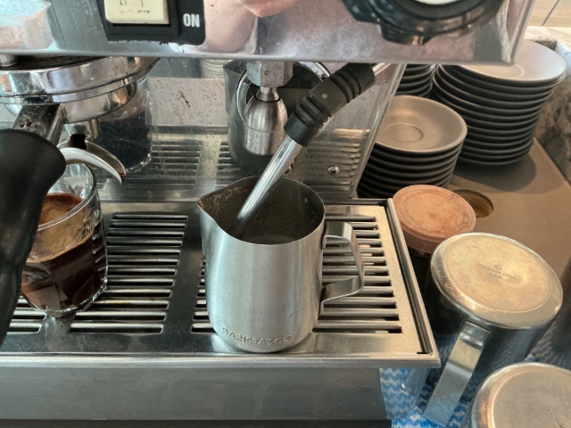 <p><span style="font-size: 16px; line-height: 1.4;">Heating Milk</span></p><ul><li><p><span style="font-size: 16px; line-height: 1.4;">Fill the milk jug to just below the spout line.</span></p></li><li><p><span style="font-size: 16px; line-height: 1.4;">Position the steam wand tip just below the milk's surface and steam while maintaining a smooth swirling motion without bubbles. Lower the jug gradually as the milk expands, heating it to <strong>60–65°C</strong>.</span></p></li><li><p><span style="font-size: 16px; line-height: 1.4;">Turn off the steam before removing the jug, wipe the steam wand clean, then tap and swirl the milk until it is silky and glossy.</span></p></li><li><p><span style="font-size: 16px; line-height: 1.4;">Pour the milk into the centre of a tilted cup, gradually levelling the cup as it fills to create a smooth pattern with an even coffee ring around the edge and milk in the centre.</span></p></li><li><p><span style="font-size: 16px; line-height: 1.4;">After making coffee, empty the used coffee grounds into the waste bucket, wipe the group handle clean, rinse the group head, and return the group handle to the machine.</span></p></li><li><p><span style="font-size: 16px; line-height: 1.4;">For tea, add the correct amount of tea to the teapot strainer, fill the pot with hot water to the top of the strainer, then close the lid.</span></p></li><li><p><span style="font-size: 16px; line-height: 1.4;">Serve tea with a clean cup and saucer, teaspoon, sugar, and milk on a tray, and deliver it to the table.</span></p></li><li><p><span style="font-size: 16px; line-height: 1.4;">Clean the milk jug, wipe down benches and the grinder area, and leave the workstation clean and tidy for the next user</span></p></li></ul><p></p>