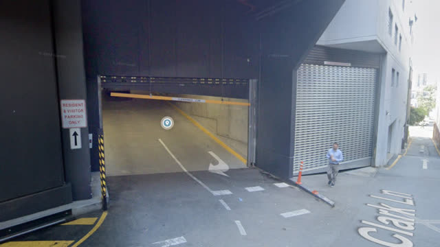 <p>Your parking entrance is via the first driveway on the left.
Use the remote to open the garage doors.</p>