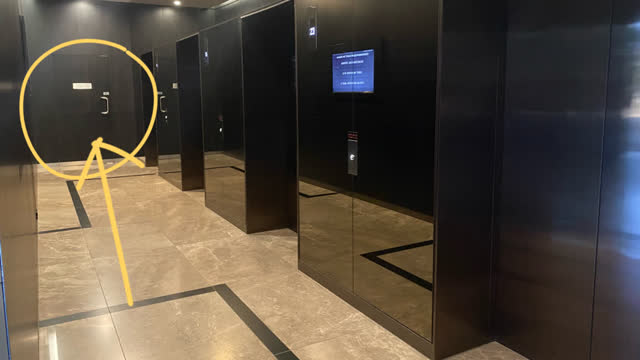 <p>There is a doorway to the left of the lifts that leads to the mail room.</p>