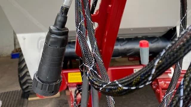 <p>Start at the hose holder on the drawbar and run the ISOBUS (black & white) loom down to the front chassis cross member.</p>